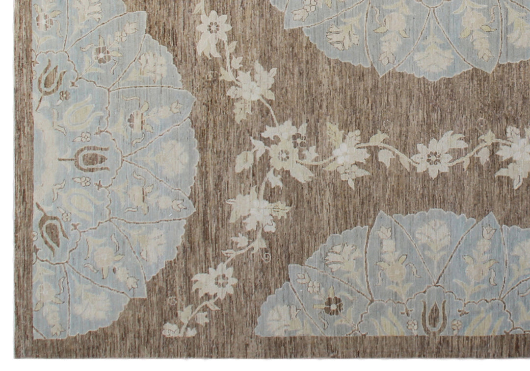 Top-down view of a luxury 9x12 Ariana rug with ivory field, blue and brown Ottoman palmettes, and short wool pile.