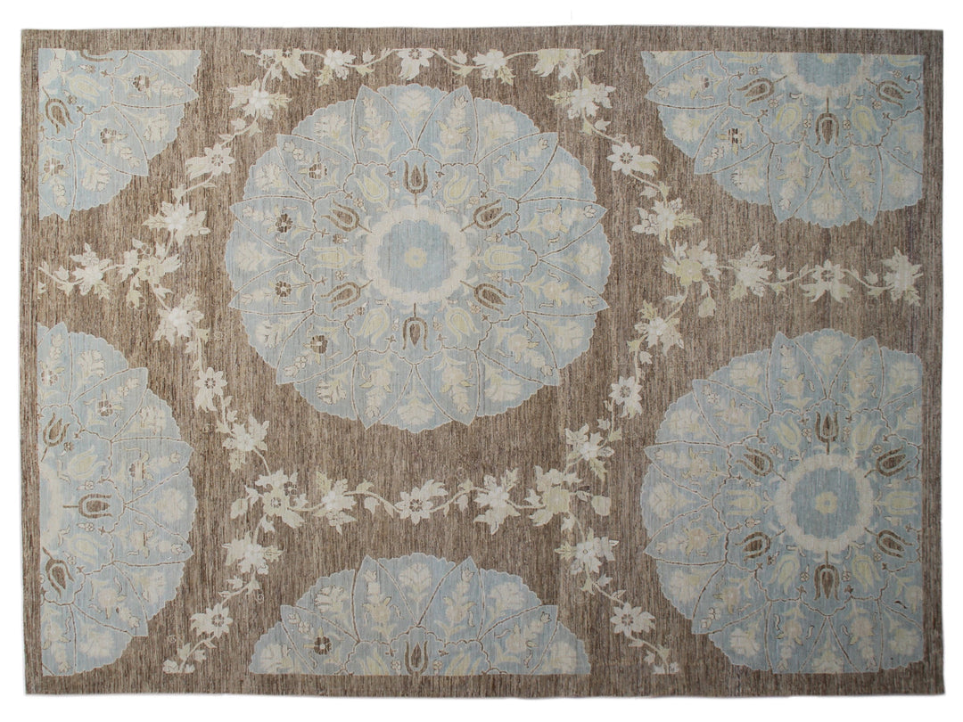Top-down view of a luxury 9x12 Ariana rug with ivory field, blue and brown Ottoman palmettes, and short wool pile.