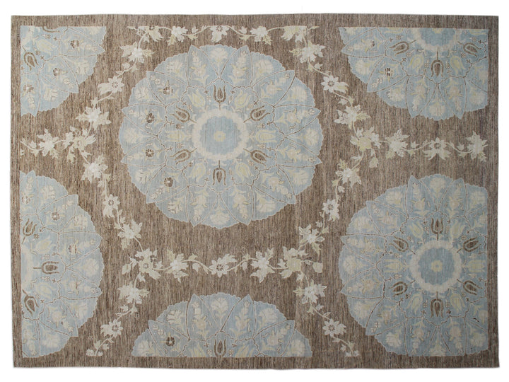 Top-down view of a luxury 9x12 Ariana rug with ivory field, blue and brown Ottoman palmettes, and short wool pile.