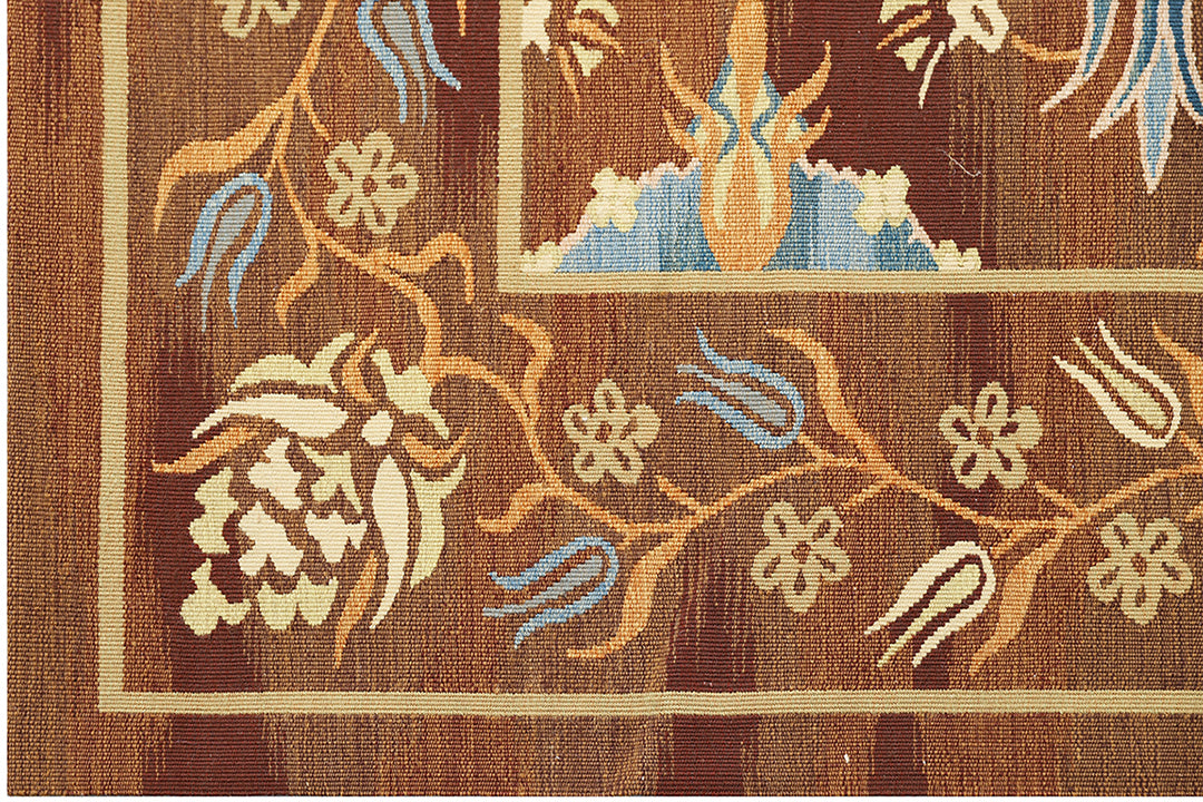 Handwoven Ottoman‑inspired kilim rug in earthy browns and vibrant blues, crafted from organic wool on a cotton foundation by Afghan artisans. High‑end geometric flatweave design.