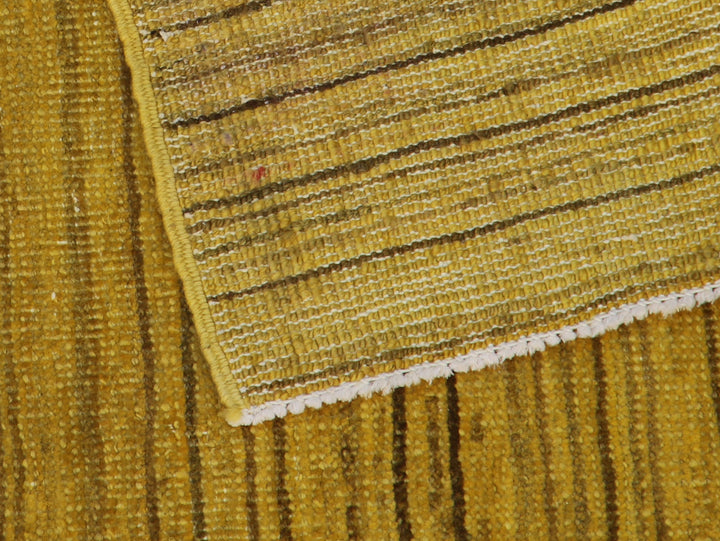 Hand-knotted wool Ariana Over-dye rug with a Mustard Gold and Brown Stria textured design, measuring 8’8” x 5’7”.