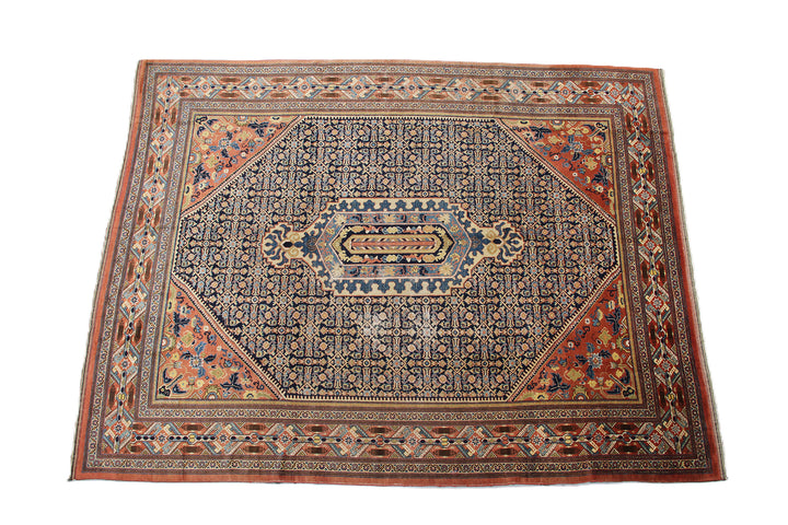 A large 9'4" x 12'2" vintage Khorasan wool rug featuring a navy blue field with intricate geometric patterns and a traditional Persian border.
