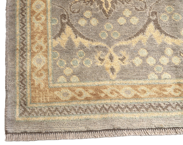 Hand-knotted 7' x 9'9" Afghan Oushak rug with an Ottoman design in soft grey, cream, and brown.