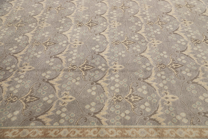 Hand-knotted 7' x 9'9" Afghan Oushak rug with an Ottoman design in soft grey, cream, and brown.