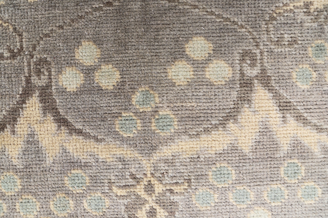 Hand-knotted 7' x 9'9" Afghan Oushak rug with an Ottoman design in soft grey, cream, and brown.