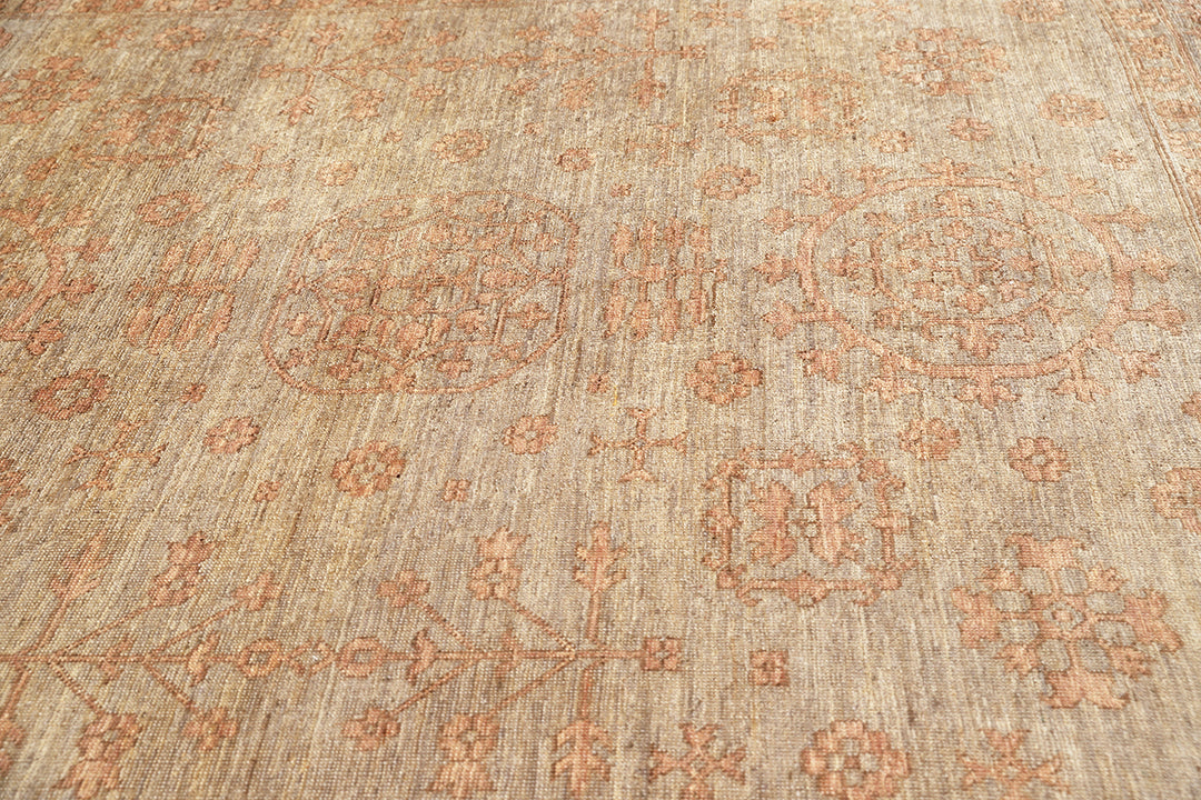 Hand-knotted 8'4" x 10' Afghan Oushak rug featuring a Samarkand medallion in soft coral and terracotta tones over a gray field.