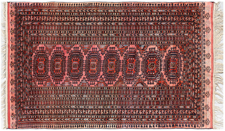Authentic Afghan Sarik Saruk design wool rug 3x1x6x6 with unusual salmon background, red, blue, brown geometric pattern, and multiple borders