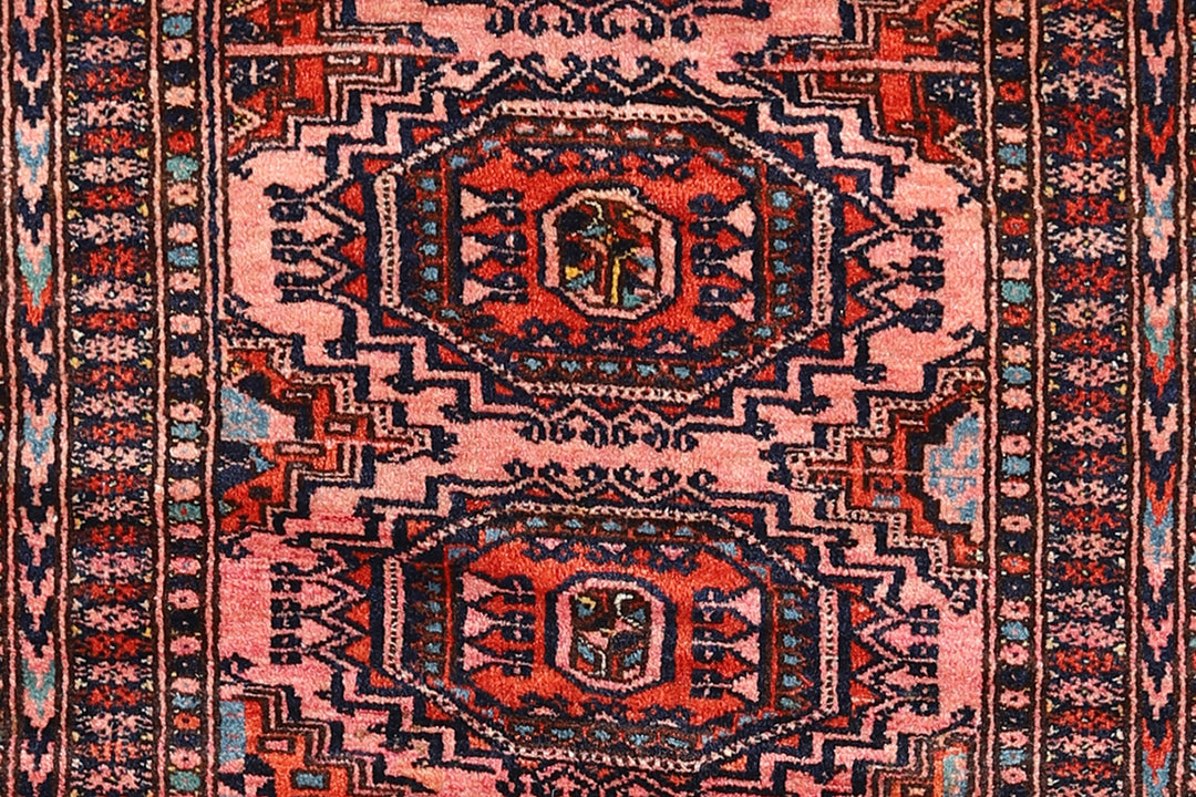 Authentic Afghan Sarik Saruk design wool rug 3x1x6x6 with unusual salmon background, red, blue, brown geometric pattern, and multiple borders