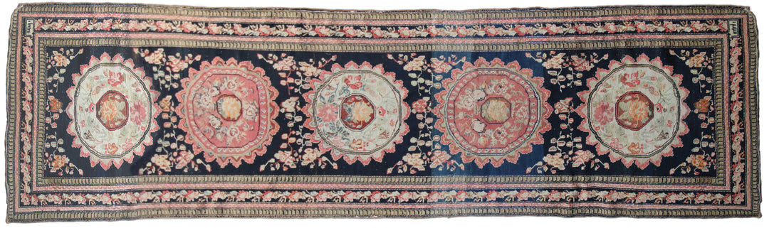 Rare antique Caucasian runner rug featuring 5 distinct geometric medallions on a deep navy blue background with coral, aqua, tan, brown, and green accents