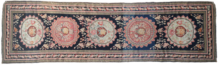 Rare antique Caucasian runner rug featuring 5 distinct geometric medallions on a deep navy blue background with coral, aqua, tan, brown, and green accents