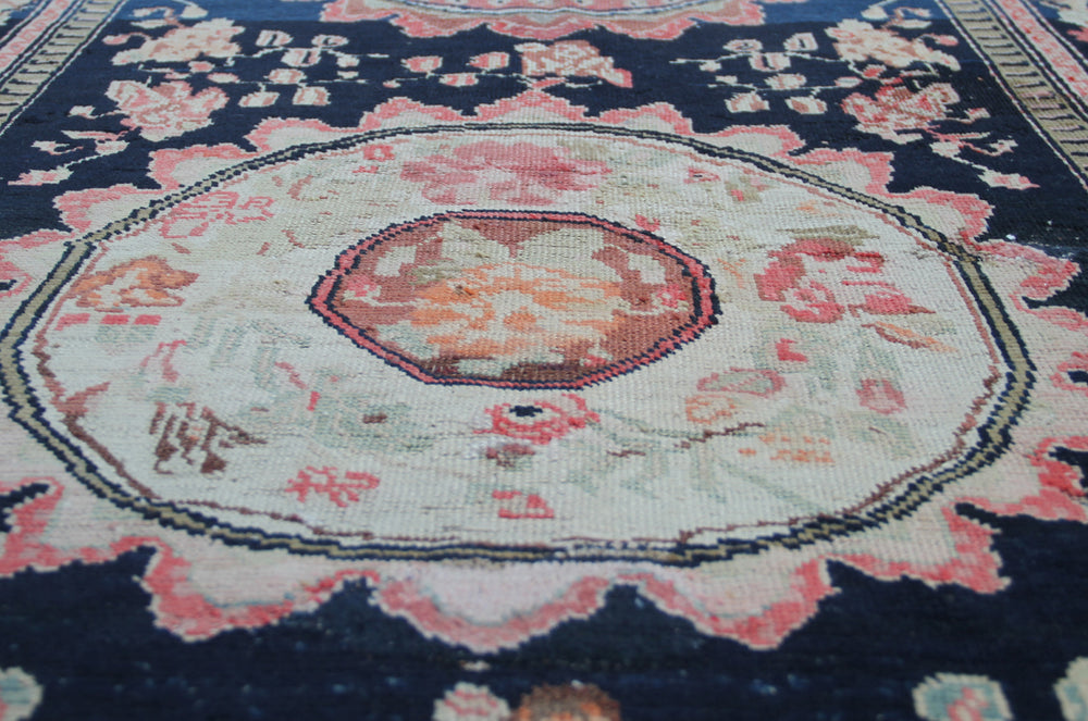 Rare antique Caucasian runner rug featuring 5 distinct geometric medallions on a deep navy blue background with coral, aqua, tan, brown, and green accents