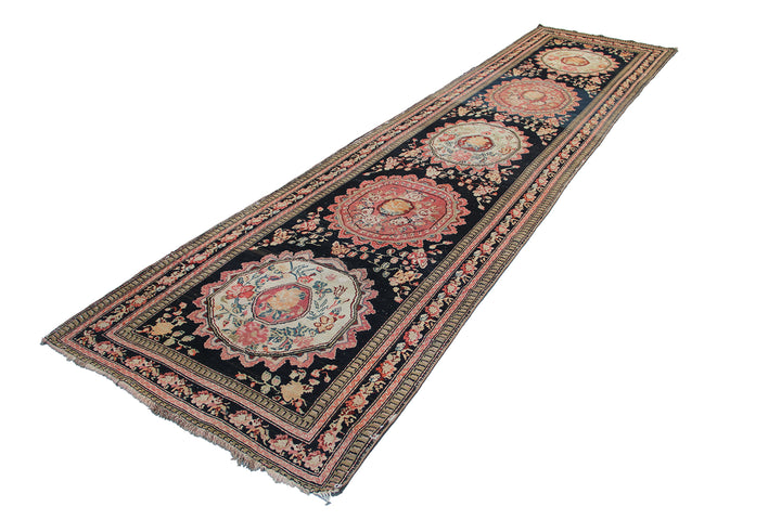 Rare antique Caucasian runner rug featuring 5 distinct geometric medallions on a deep navy blue background with coral, aqua, tan, brown, and green accents