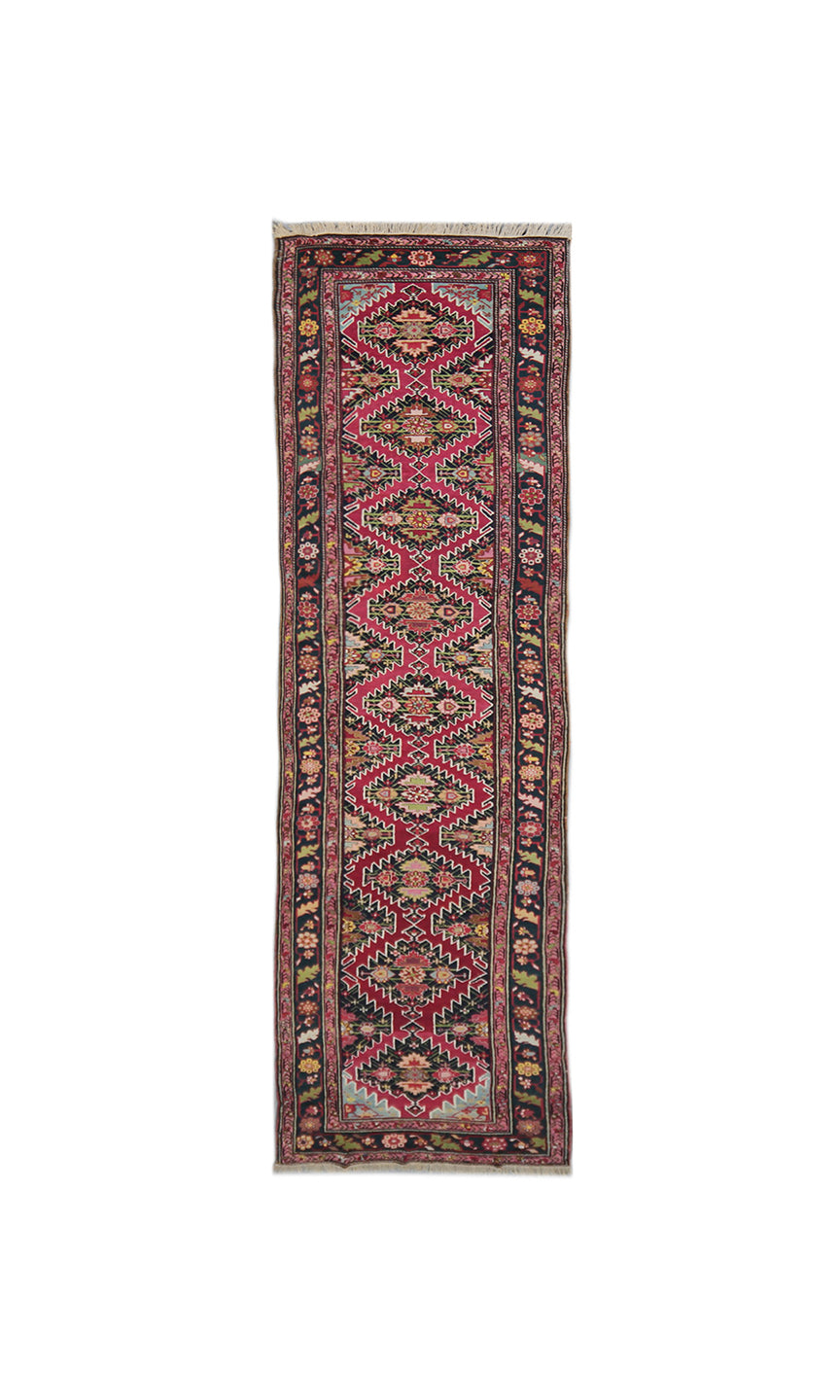 Full-length view of an authentic 3x19 antique Caucasian hand-knotted runner rug, featuring traditional Armenian geometric patterns in magenta, sage green, and navy blue.