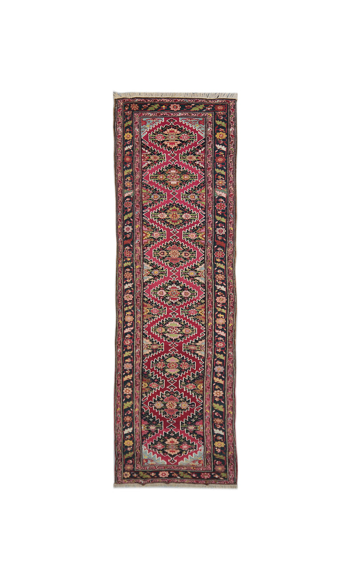 Full-length view of an authentic 3x19 antique Caucasian hand-knotted runner rug, featuring traditional Armenian geometric patterns in magenta, sage green, and navy blue.