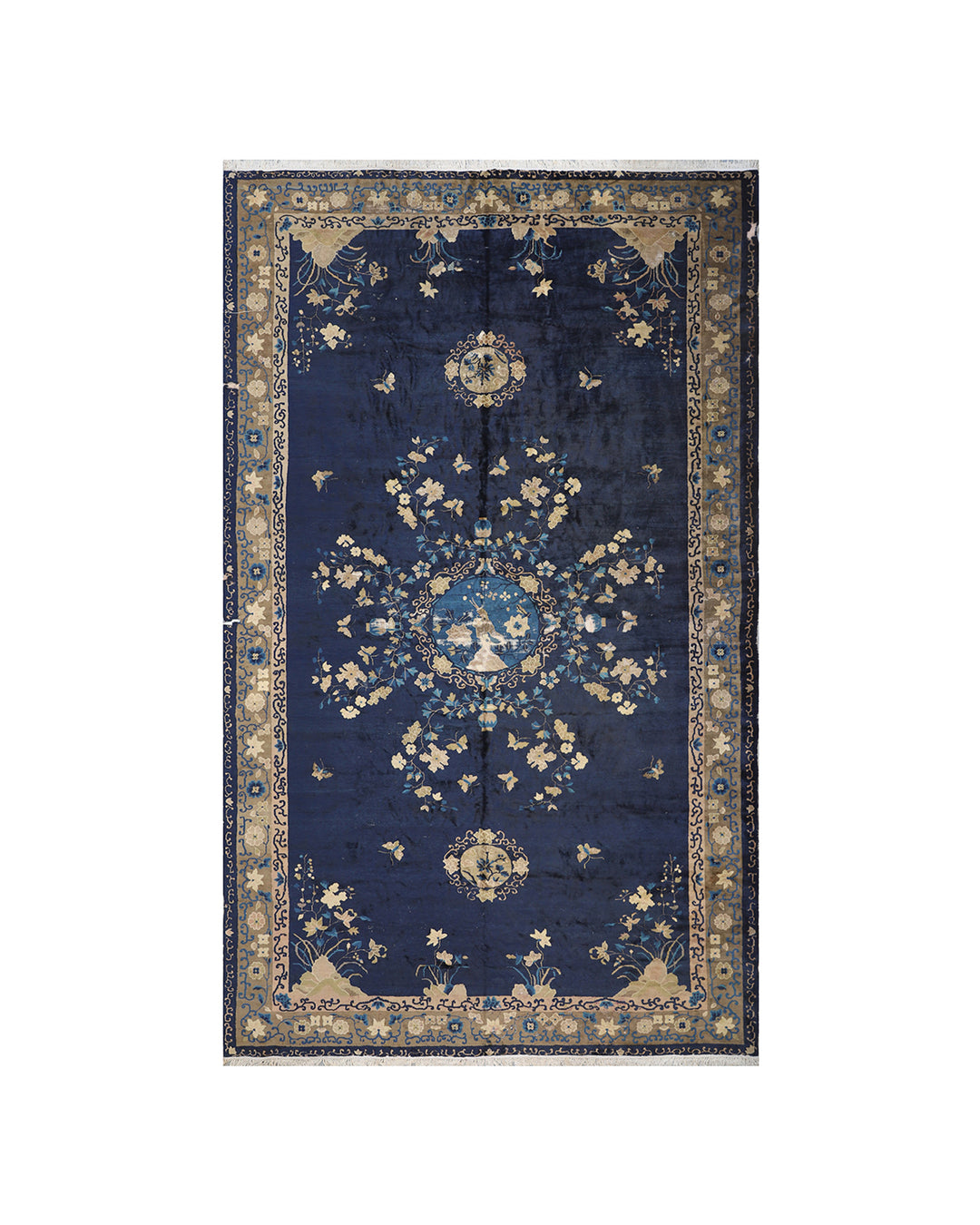 Large antique navy blue Chinese Art Deco Peking wool rug with tan floral motifs.