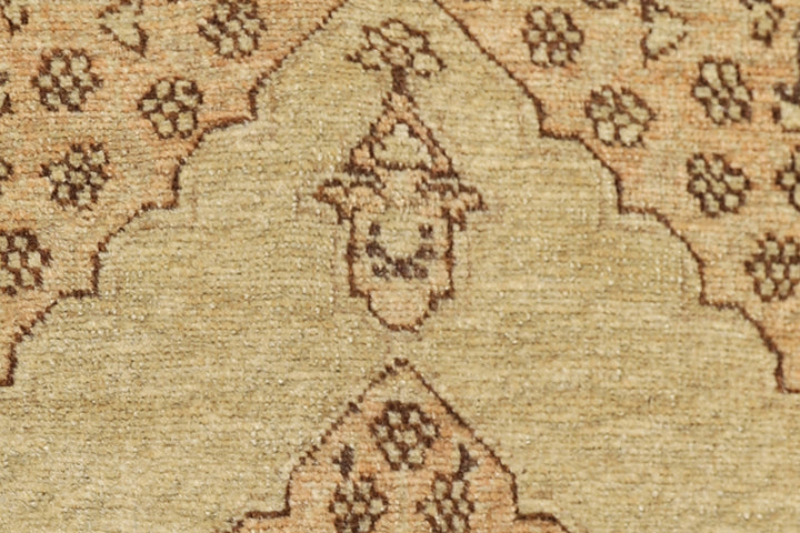 Small antique Haji Jalili design Persian rug featuring tan and gold medallion open field with intricate spandrels and border