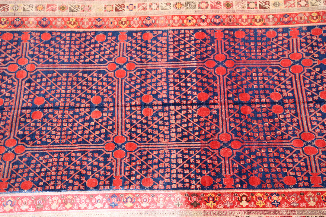 Rare 6x11 antique Samarkand hand-knotted wool area rug featuring red pomegranate motifs on a deep navy blue background by Ariana Rugs.