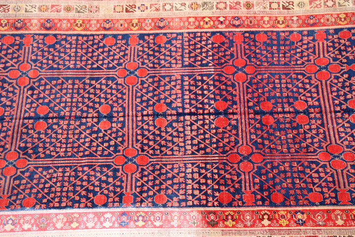 Rare 6x11 antique Samarkand hand-knotted wool area rug featuring red pomegranate motifs on a deep navy blue background by Ariana Rugs.