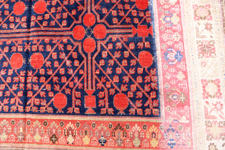 Rare 6x11 antique Samarkand hand-knotted wool area rug featuring red pomegranate motifs on a deep navy blue background by Ariana Rugs.