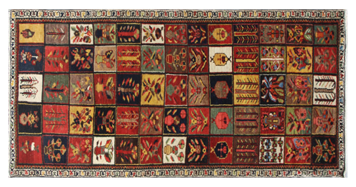 A multicolored antique Persian Bakhtiari rug with geometric and floral patterns.