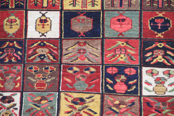 Antique semi-antique Persian Bakhtiari rug 3x6 with geometric Four Seasons garden design in colorful red, blue, green, and gold jewel tones