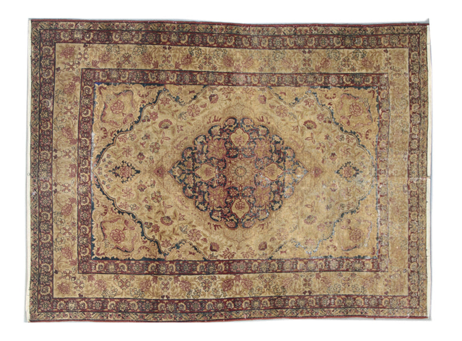 Antique Persian Kermanshah wool area rug with a central floral medallion in warm tan and deep navy blue with low pile