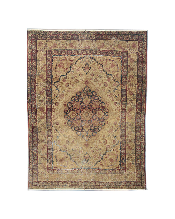 Antique Persian Kermanshah wool area rug with a central floral medallion in warm tan and deep navy blue with low pile