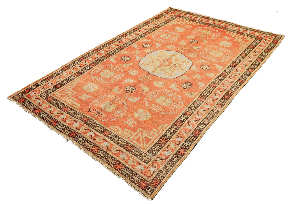 Authentic antique hand-knotted Samarkand Khotan wool area rug featuring bold black and grey geometric medallions on a vibrant orange field