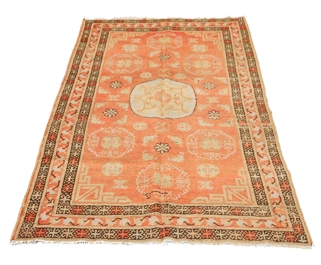 Authentic antique hand-knotted Samarkand Khotan wool area rug featuring bold black and grey geometric medallions on a vibrant orange field