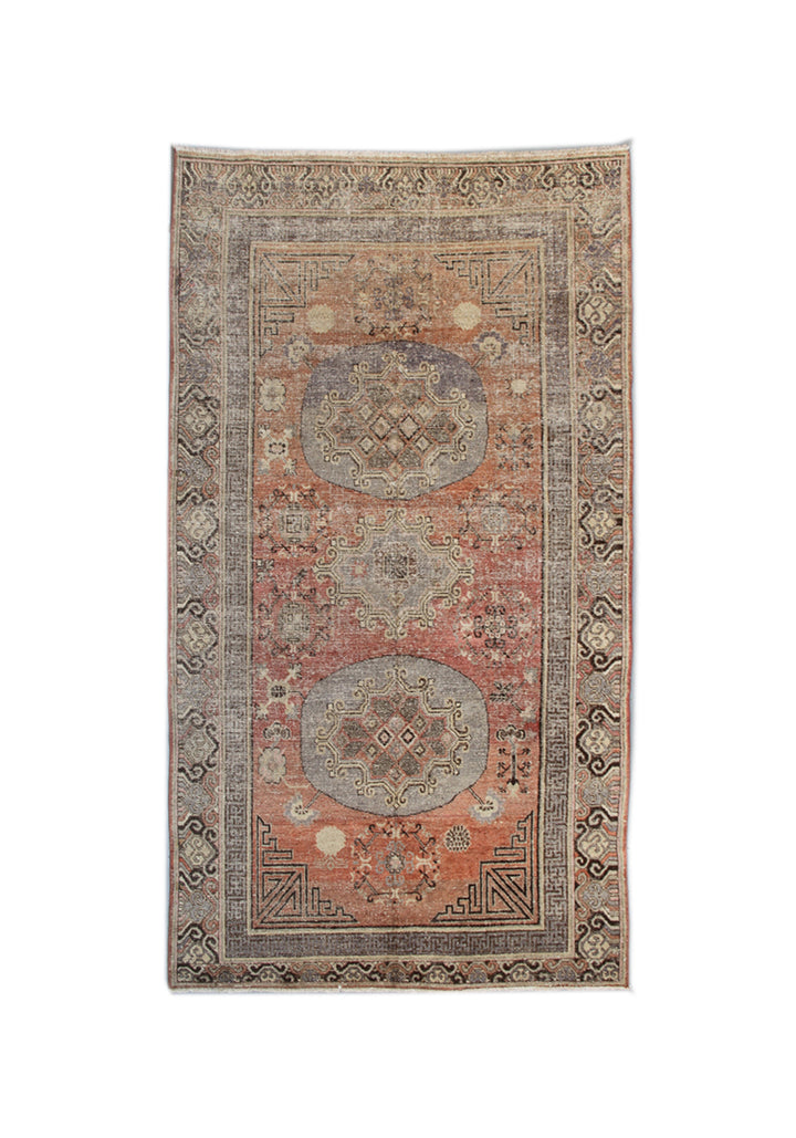 Authentic antique hand-knotted Samarkand Khotan wool area rug featuring classic medallions on a rich orange-red field with brown and cream accents