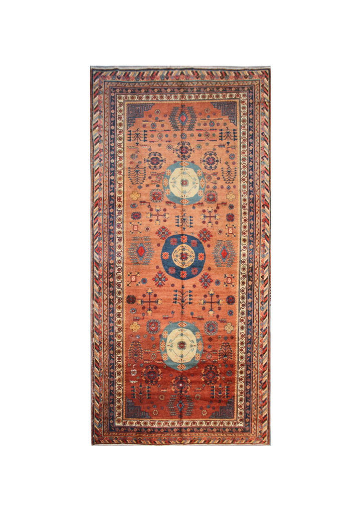 Authentic antique hand-knotted Samarkand Khotan wool area rug featuring geometric medallions in blue, rust, and terracotta on a peach and ivory field