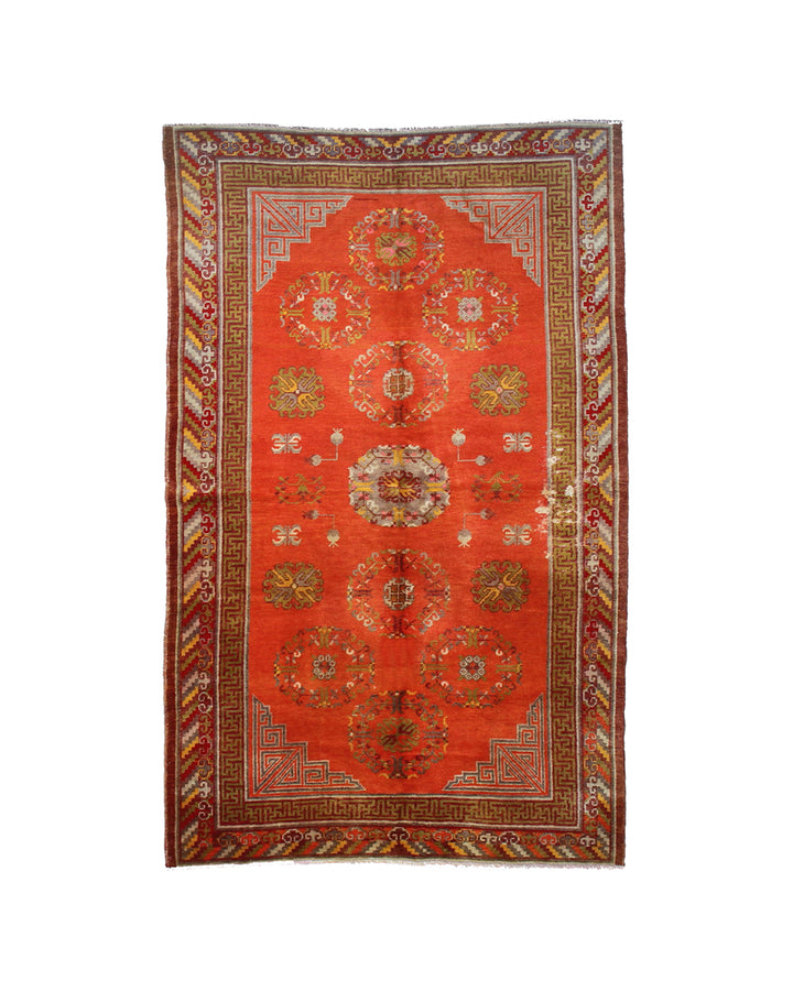 Authentic antique hand-knotted Samarkand Khotan wool area rug featuring a central medallion on a rich red field