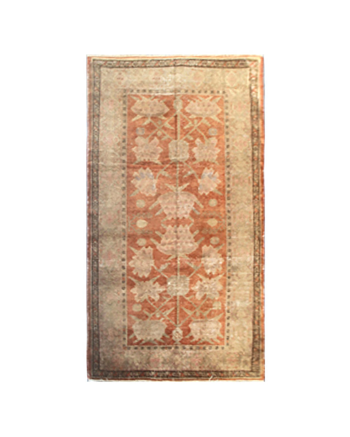 Authentic antique hand-knotted Samarkand Khotan wool area rug featuring salmon pink floral motifs on a warm rust field