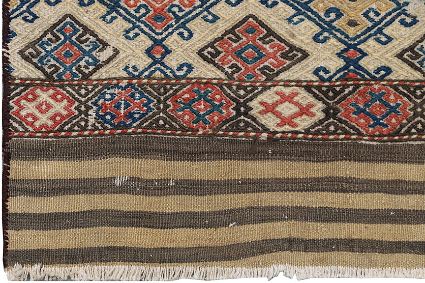 Traditional woven rug with geometric patterns and striped design.