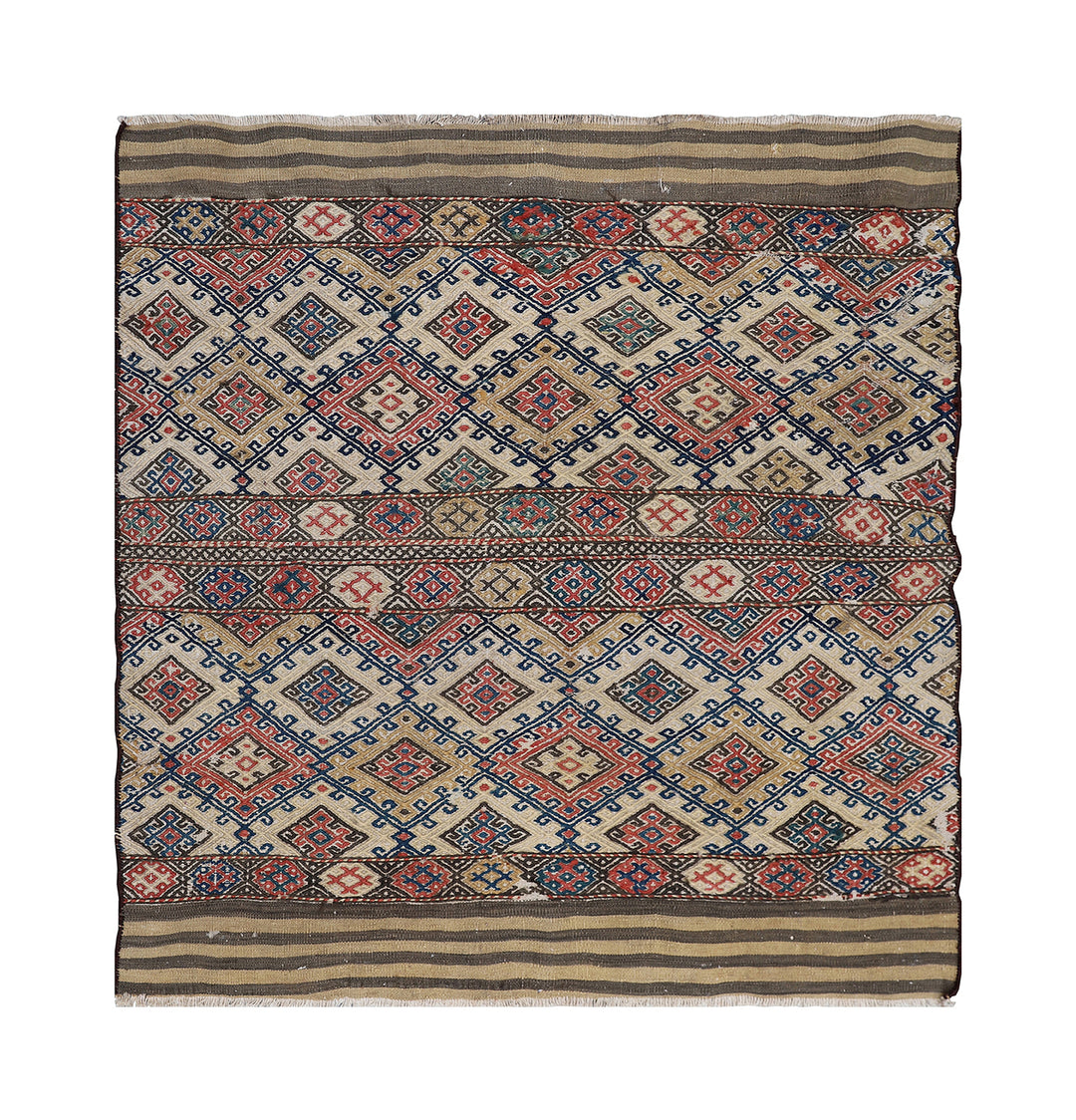 Traditional patterned fabric with geometric design on a white background
