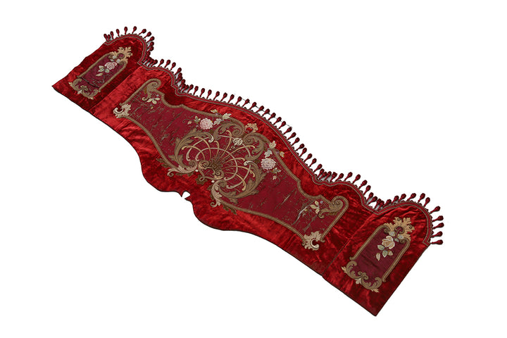 Red embroidered fabric with intricate patterns on a white background