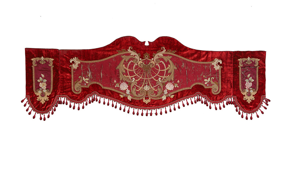 Decorative red valance with gold embroidery on a white background