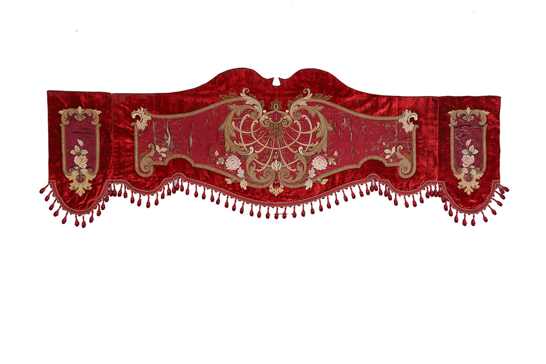 Decorative red valance with gold embroidery on a white background