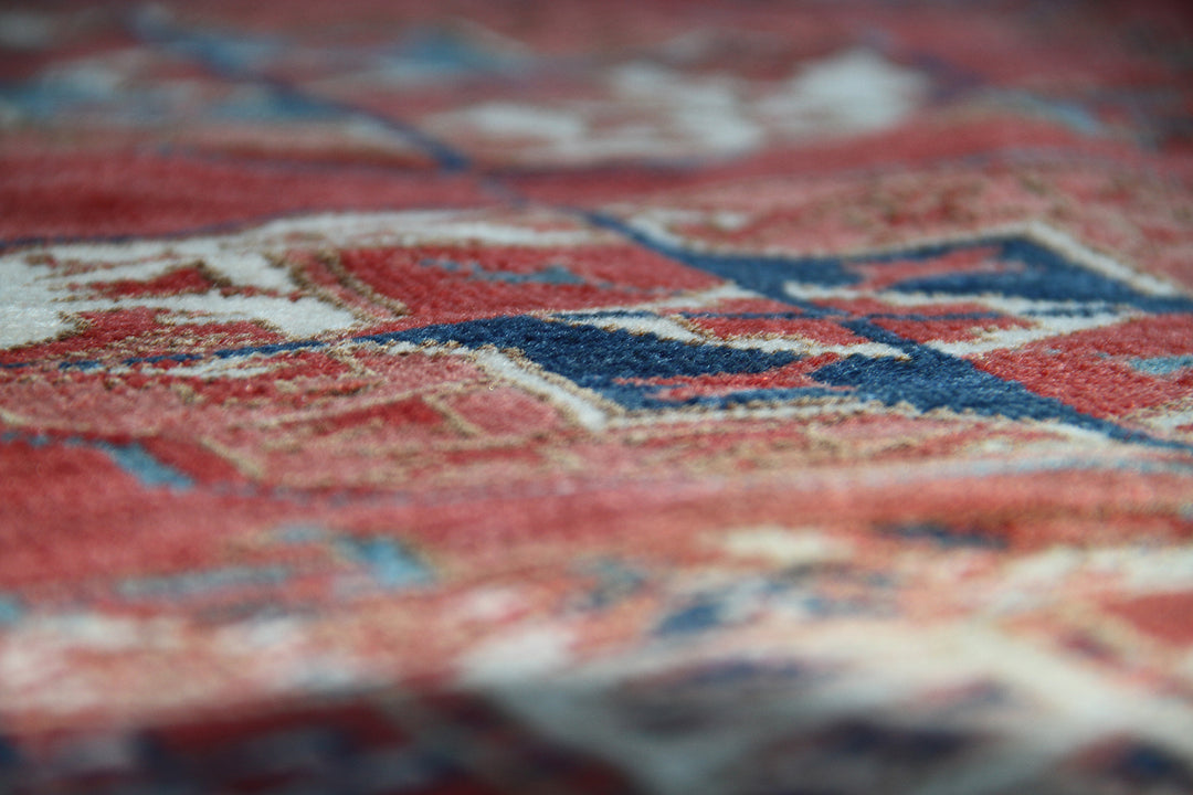 11'1" x 7'1" Antique Turkmen main rug featuring a deep red background with hand-knotted geometric motifs in navy, green, white, and brown.