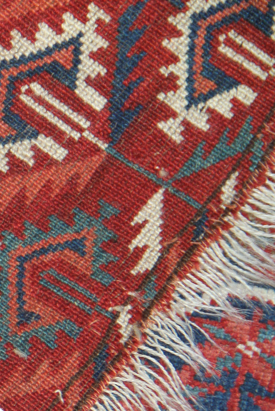 11'1" x 7'1" Antique Turkmen main rug featuring a deep red background with hand-knotted geometric motifs in navy, green, white, and brown.