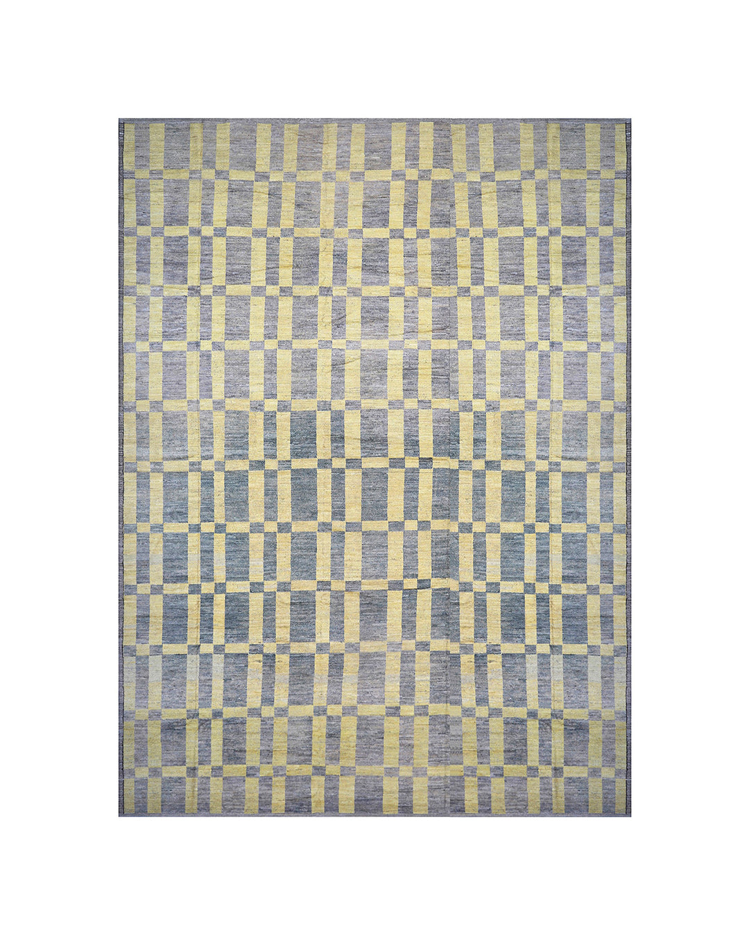 An overhead view of a massive 16x20 authentic Moroccan style long pile shag rug from the Ariana Barchi Collection, featuring a grey and yellow geometric pattern hand-woven by Hazara women weavers.