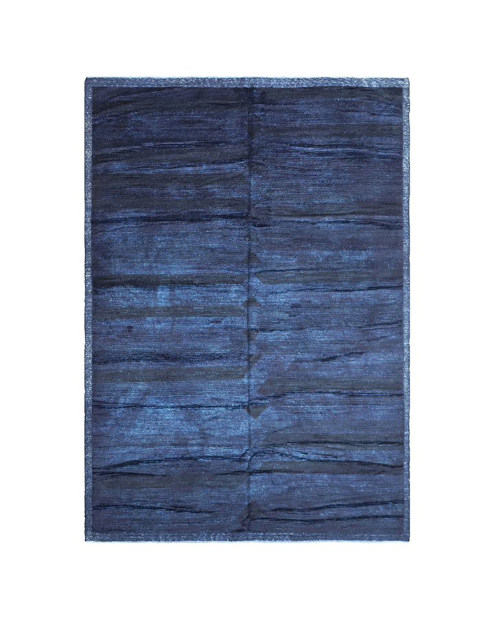 Hand-knotted 6'3" x 9'2" Moroccan-style solid deep blue wool area rug with a rich, soft pile from the Ariana Barchi Collection.