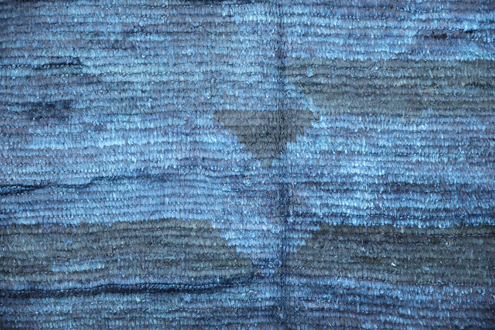 Hand-knotted 6'3" x 9'2" Moroccan-style solid deep blue wool area rug with a rich, soft pile from the Ariana Barchi Collection.
