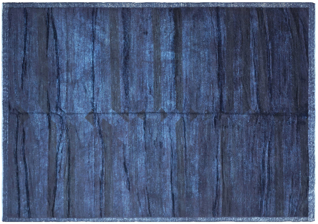 Hand-knotted 6'3" x 9'2" Moroccan-style solid deep blue wool area rug with a rich, soft pile from the Ariana Barchi Collection.