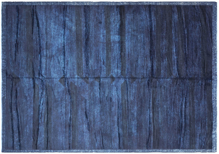 Hand-knotted 6'3" x 9'2" Moroccan-style solid deep blue wool area rug with a rich, soft pile from the Ariana Barchi Collection.