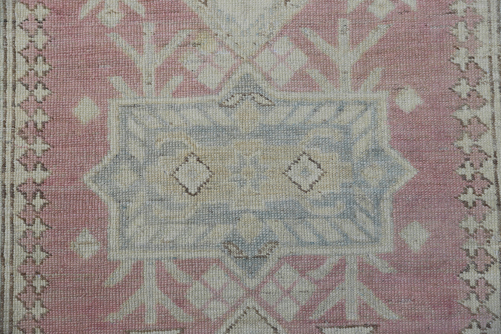 Unique hand-knotted Ariana Hazara Caucasian runner rug with geometric designs in pink, ivory, blue, and brown