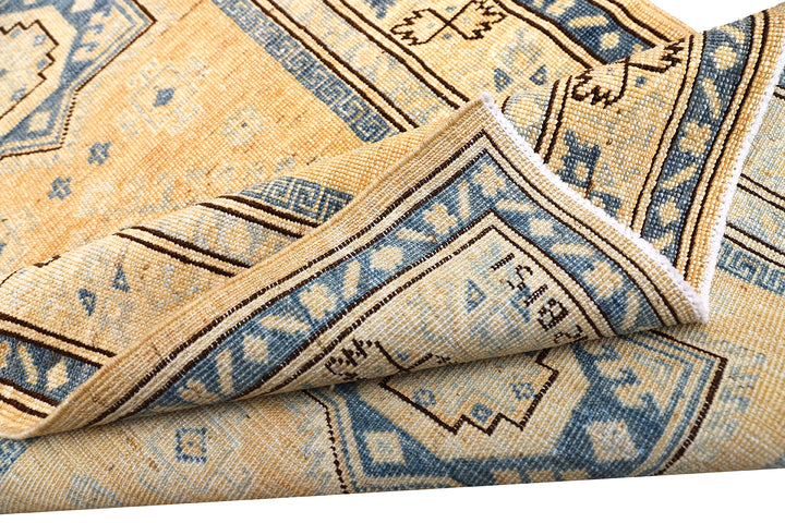 Hand-knotted 2'9"x4'2" Ariana Hazara rug featuring blue geometric medallions on an apricot background