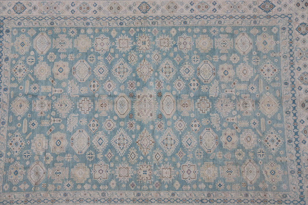 Authentic Ariana Hazara Collection 10x14 wool area rug. Features a geometric Caucasian design with a blue field, black, white, and pink accents, hand-knotted by Hazara women in Afghanistan.