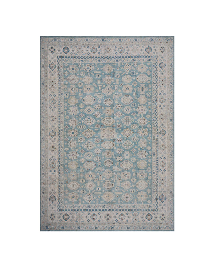 Authentic Ariana Hazara Collection 10x14 wool area rug. Features a geometric Caucasian design with a blue field, black, white, and pink accents, hand-knotted by Hazara women in Afghanistan.