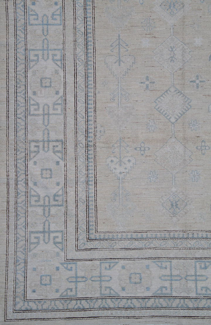 Authentic Ariana Hazara Collection 10x13 hand-knotted wool rug featuring geometric Caucasian tribal design in tan, blue, black, and white colors.